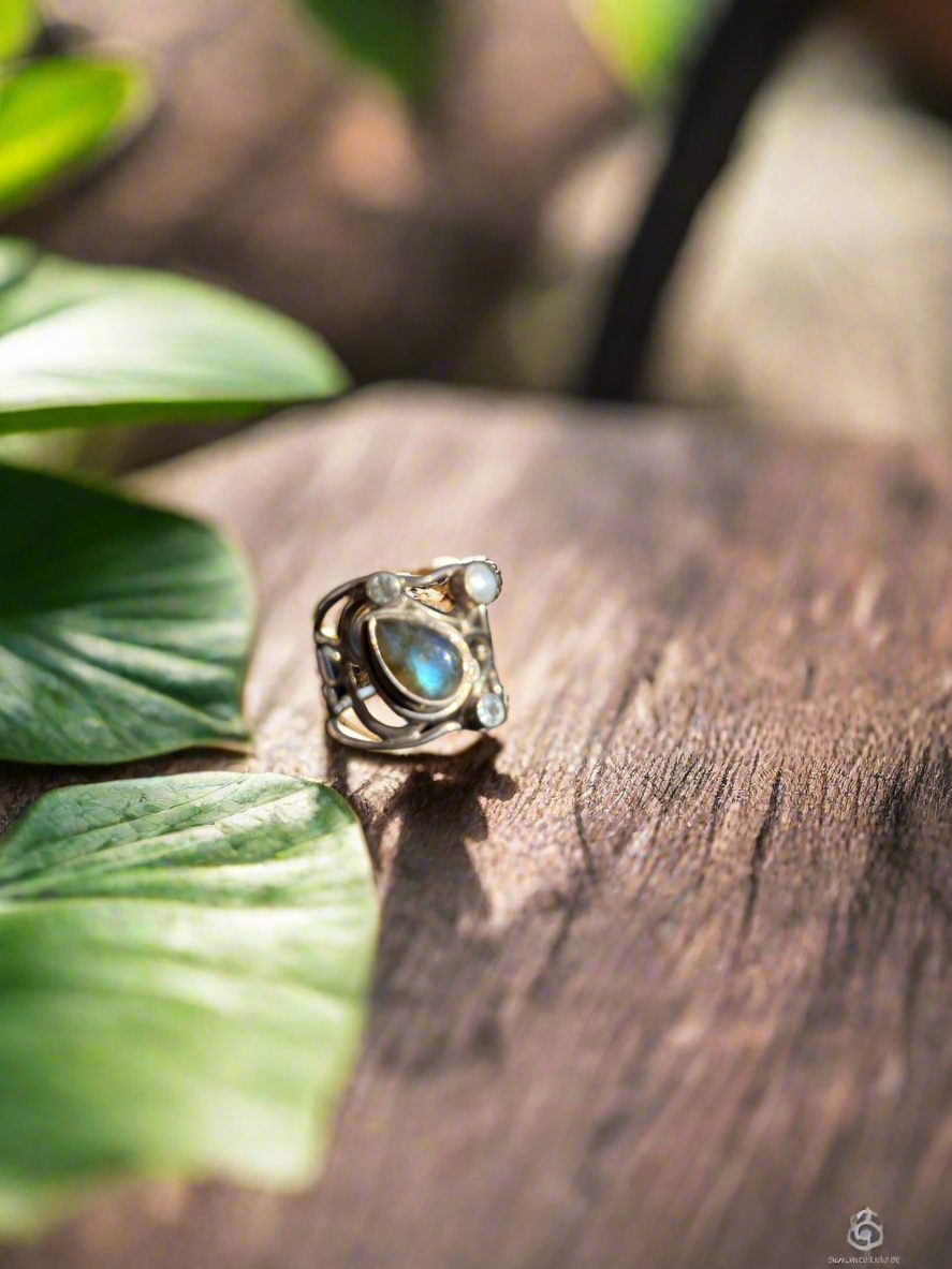 Labradorite and moonstone ring, mystical gemstone ring, artisan-crafted labradorite ring, moonstone and labradorite jewelry, spiritual gemstone ring, labradorite moonstone band, bohemian gemstone jewelry, healing crystal ring, moonstone for intuition ring, labradorite for protection ring, unique gemstone ring, handcrafted labradorite moonstone ring, chakra balancing ring, natural stone jewelry, labradorite and moonstone statement ring