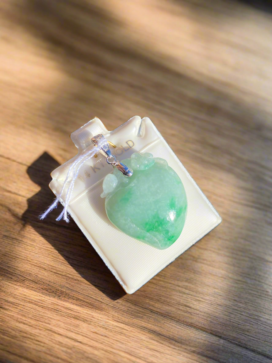 Jade heart pendant, jade and diamond necklace, green jade jewelry, heart-shaped jade pendant, jade talisman necklace, harmony and love symbol jewelry, diamond-accented jade pendant, jade healing crystal necklace, sterling silver jade pendant, unique gemstone heart pendant, spiritual jade necklace, luxury jade jewelry, green gemstone heart pendant, handcrafted jade and diamond necklace, jade charm for balance and love