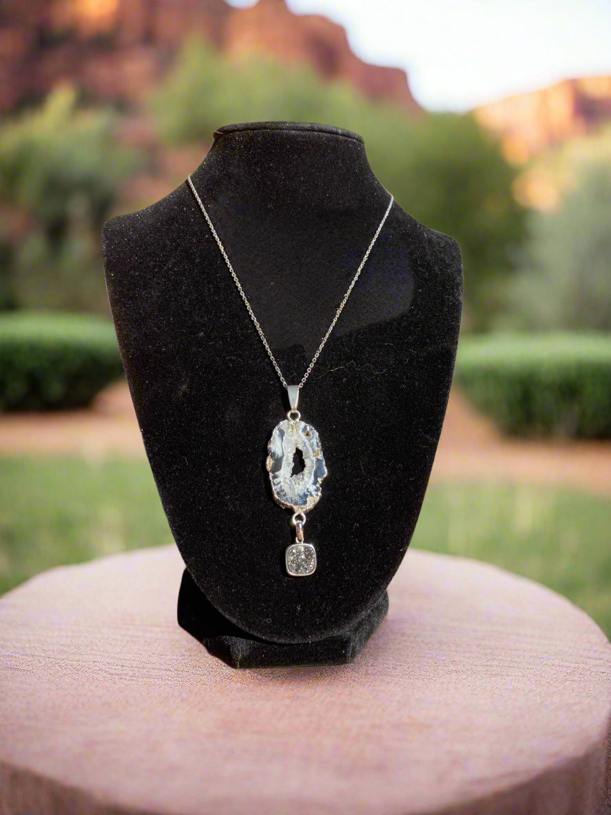 Dark blue agate pendant, black agate geode necklace, drusy crystal pendant, raw agate jewelry, natural geode pendant, blue and black gemstone necklace, bohemian crystal pendant, agate healing stone necklace, statement geode jewelry, drusy accent pendant, unique gemstone pendant, spiritual agate jewelry, chakra balancing necklace, handcrafted agate pendant, raw crystal elegance necklace.