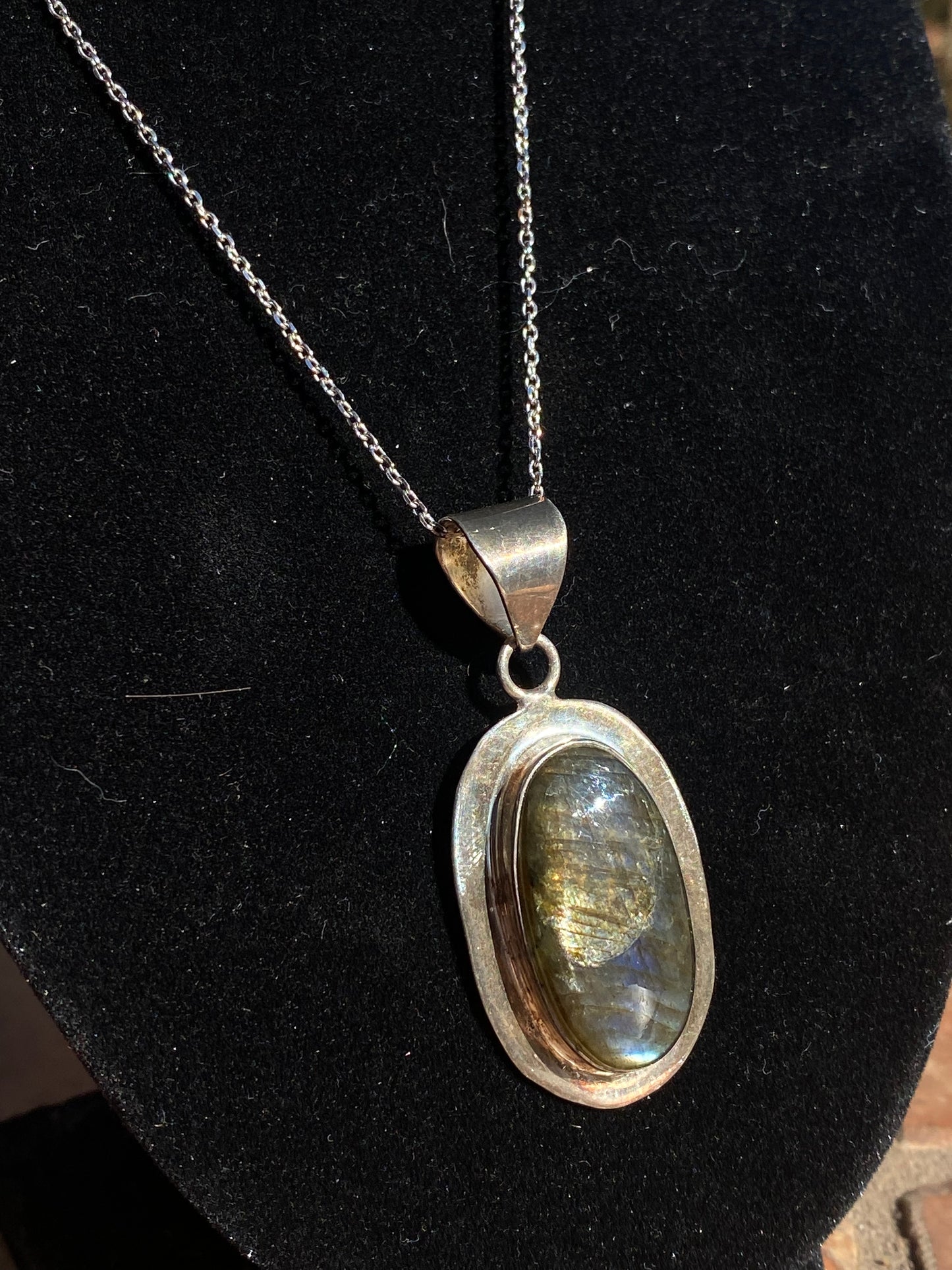 Labradorite crystal pendant, handcrafted labradorite necklace, oval labradorite charm, mystical labradorite jewelry, gemstone energy pendant, iridescent labradorite stone, spiritual crystal necklace, healing labradorite pendant, metaphysical labradorite jewelry, protective stone necklace, chakra-balancing jewelry, unique gemstone pendant, shimmering labradorite necklace, Labradorite pendant for transformation, holistic crystal jewelry