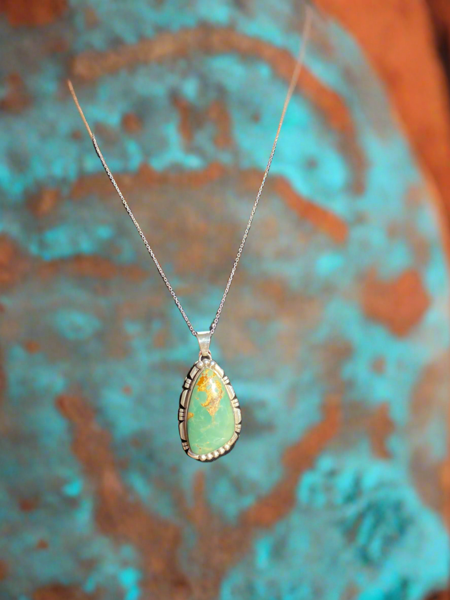 Natural green turquoise pendant, green turquoise crystal necklace, sterling silver turquoise pendant, earthy gemstone jewelry, turquoise stone necklace, bohemian turquoise pendant, healing turquoise crystal, southwestern jewelry design, handcrafted turquoise necklace, oval green turquoise pendant, unique gemstone pendant, grounding energy necklace, natural turquoise jewelry, statement turquoise necklace, green turquoise charm