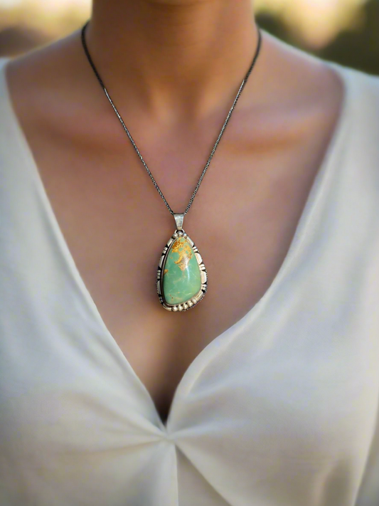 Natural green turquoise pendant, green turquoise crystal necklace, sterling silver turquoise pendant, earthy gemstone jewelry, turquoise stone necklace, bohemian turquoise pendant, healing turquoise crystal, southwestern jewelry design, handcrafted turquoise necklace, oval green turquoise pendant, unique gemstone pendant, grounding energy necklace, natural turquoise jewelry, statement turquoise necklace, green turquoise charm