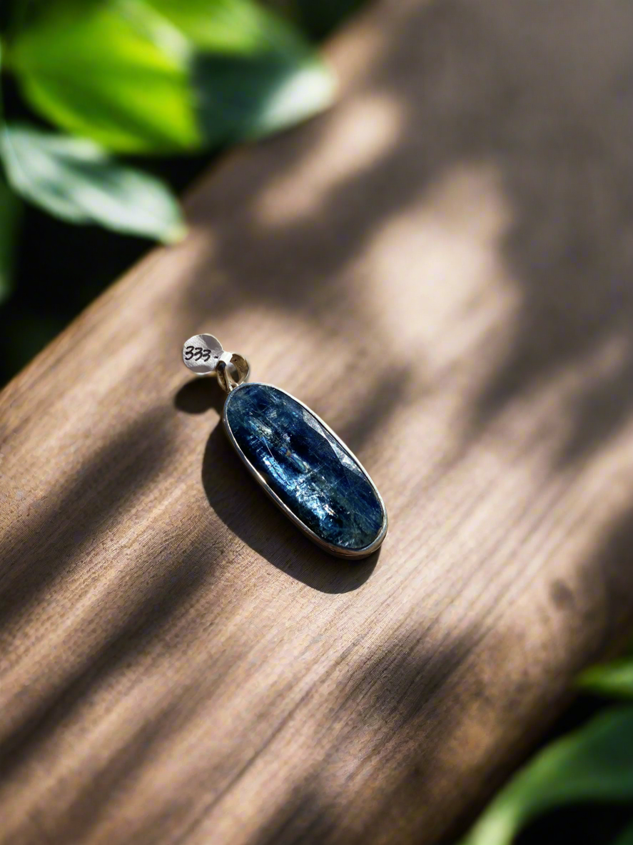 Rare blue kyanite pendant, kyanite gemstone jewelry, sterling silver kyanite necklace, natural blue kyanite charm, statement gemstone pendant, healing kyanite crystal necklace, blue kyanite for throat chakra, artisan kyanite pendant, high-vibration kyanite jewelry, unique gemstone necklace, bohemian kyanite pendant, rare crystal jewelry, kyanite energy necklace, handcrafted blue kyanite pendant, spiritual gemstone charm