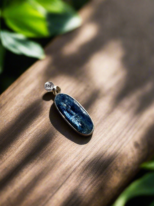 Rare blue kyanite pendant, kyanite gemstone jewelry, sterling silver kyanite necklace, natural blue kyanite charm, statement gemstone pendant, healing kyanite crystal necklace, blue kyanite for throat chakra, artisan kyanite pendant, high-vibration kyanite jewelry, unique gemstone necklace, bohemian kyanite pendant, rare crystal jewelry, kyanite energy necklace, handcrafted blue kyanite pendant, spiritual gemstone charm