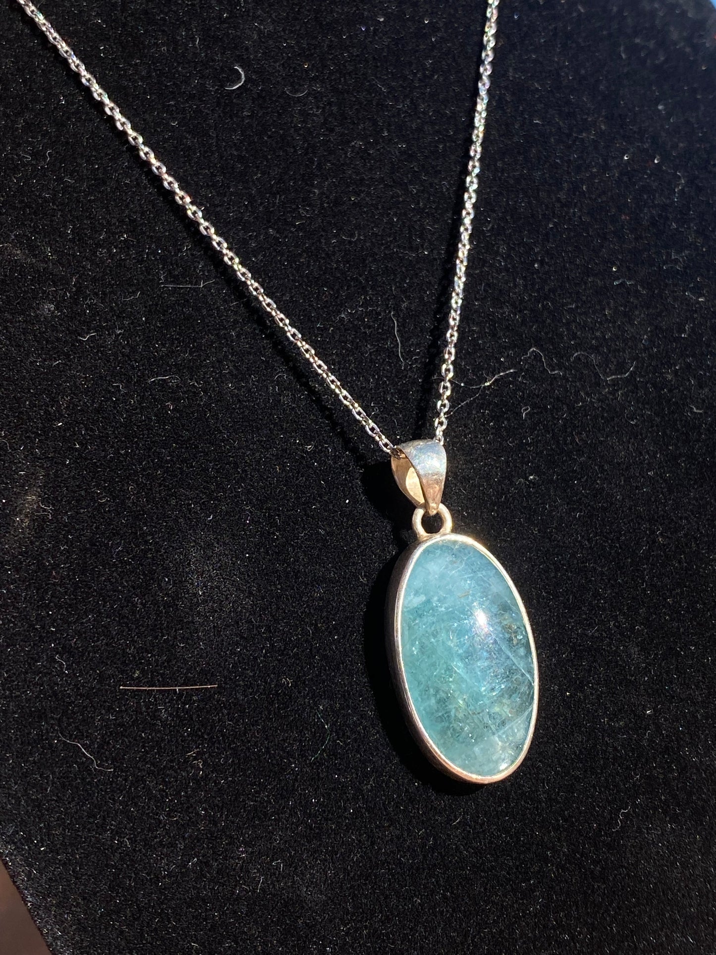 Apatite crystal pendant, oval apatite necklace, blue crystal pendant, apatite healing necklace, energy-balancing jewelry, spiritual gemstone pendant, calming apatite stone, metaphysical crystal jewelry, throat chakra pendant, natural apatite oval charm, gemstone healing necklace, apatite stone necklace, unique blue gemstone pendant, holistic crystal jewelry, apatite energy necklace