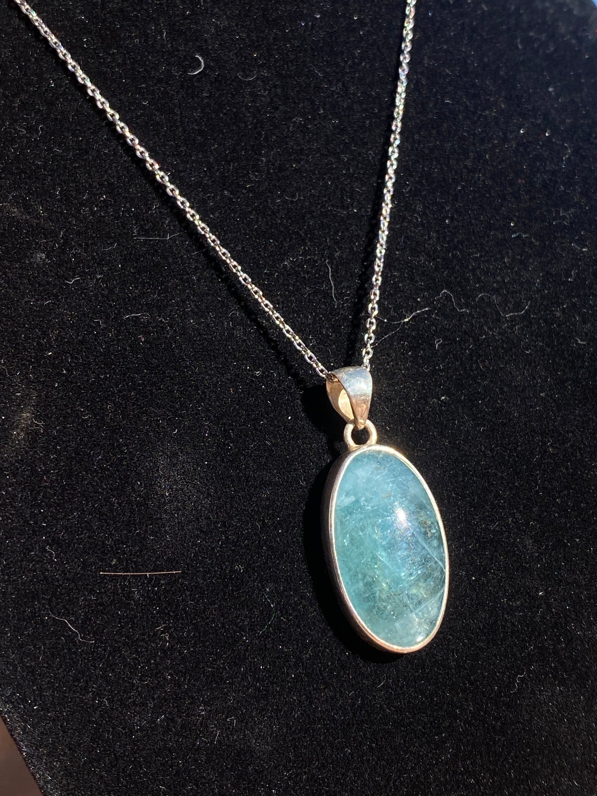 Apatite crystal pendant, oval apatite necklace, blue crystal pendant, apatite healing necklace, energy-balancing jewelry, spiritual gemstone pendant, calming apatite stone, metaphysical crystal jewelry, throat chakra pendant, natural apatite oval charm, gemstone healing necklace, apatite stone necklace, unique blue gemstone pendant, holistic crystal jewelry, apatite energy necklace