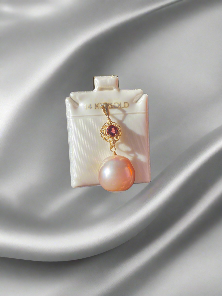 14K gold pearl pendant, pink pearl necklace, gold and garnet jewelry, luxury pearl pendant, garnet and pearl charm, vintage-inspired pearl pendant, elegant pink pearl jewelry, garnet accent necklace, statement pearl necklace, pink pearl and gold pendant, fine jewelry gift ideas, unique pearl jewelry, gemstone and pearl necklace, handcrafted pearl pendant, 14K gold pink pearl charm
