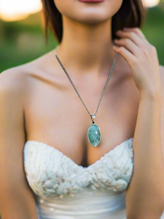 Apatite crystal pendant, oval apatite necklace, blue crystal pendant, apatite healing necklace, energy-balancing jewelry, spiritual gemstone pendant, calming apatite stone, metaphysical crystal jewelry, throat chakra pendant, natural apatite oval charm, gemstone healing necklace, apatite stone necklace, unique blue gemstone pendant, holistic crystal jewelry, apatite energy necklace